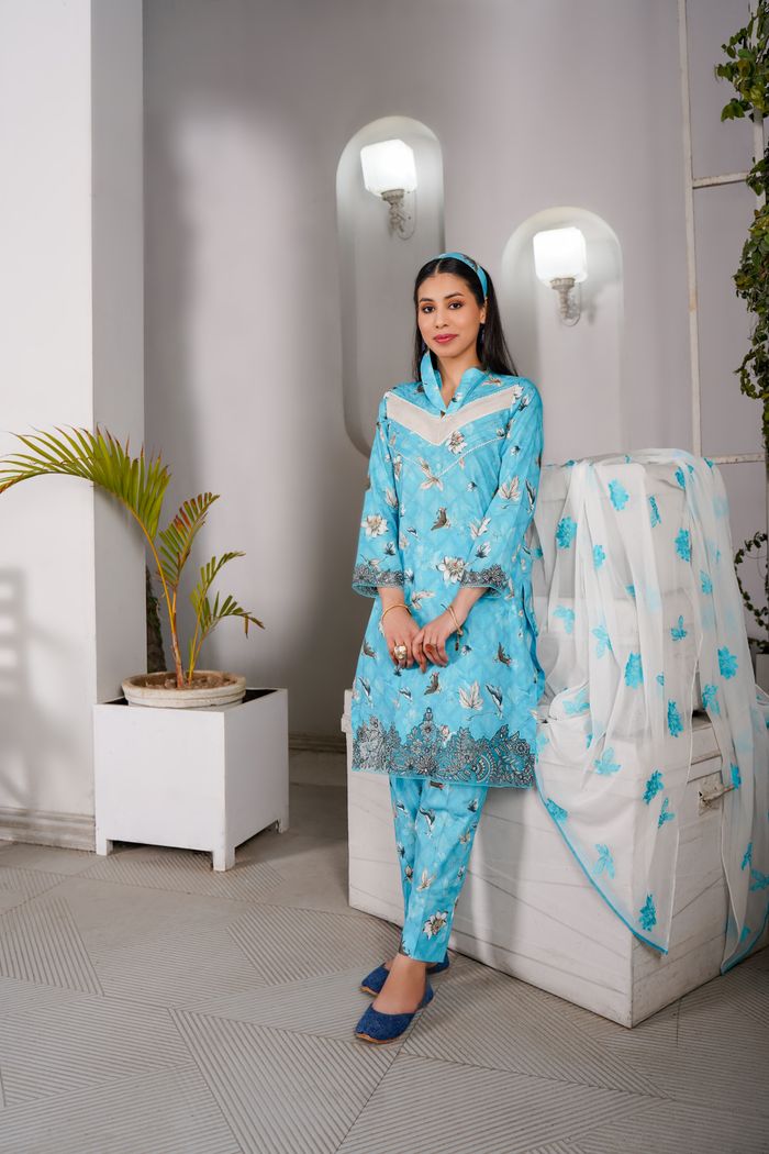 Crafting Captivating Headlines: Your awesome post title goes here Elegant woman in traditional blue attire standing indoors, exuding grace and style.