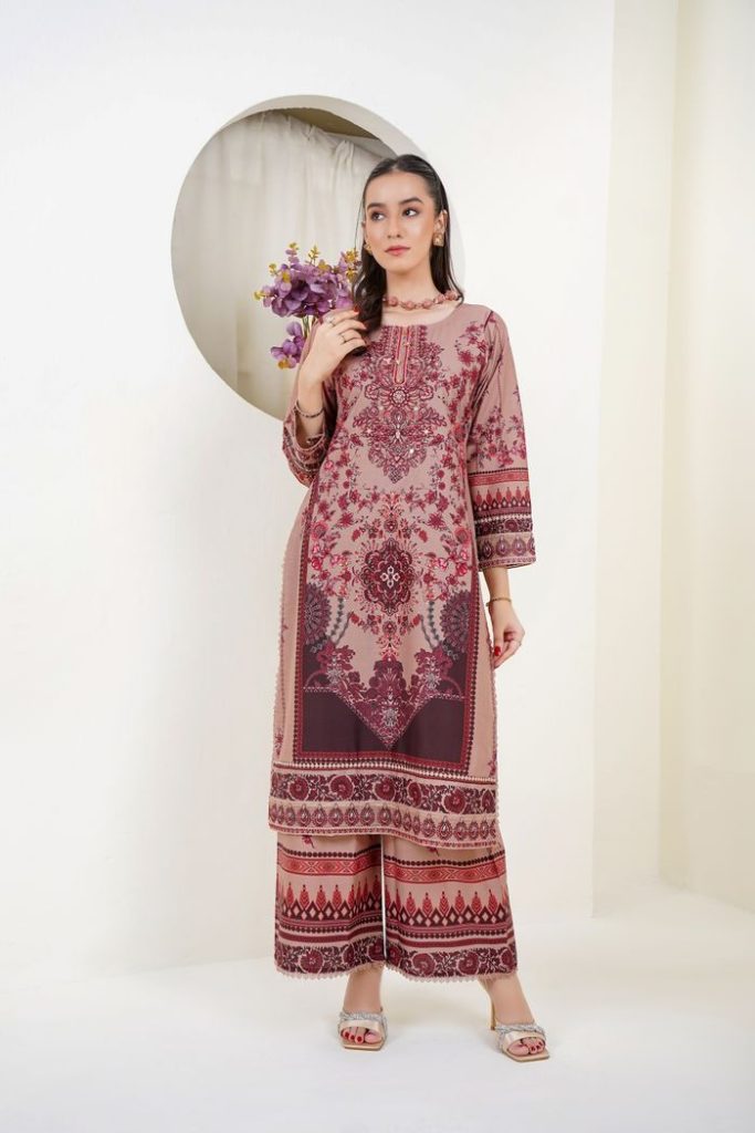 Model showcasing an elegant traditional dress with intricate patterns, in a studio setting in Lahore, Pakistan.